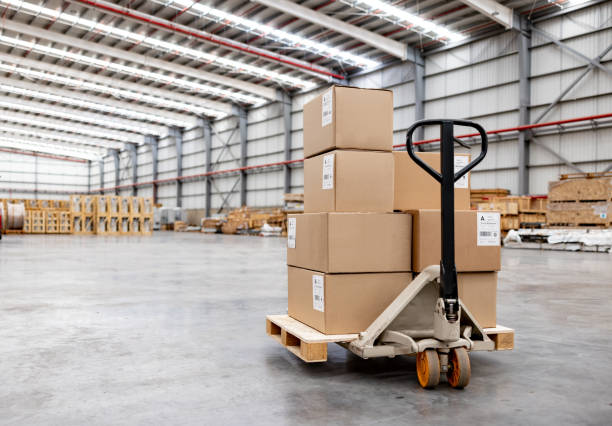 Pallet jack moving boxes at a distribution warehouse stock photo