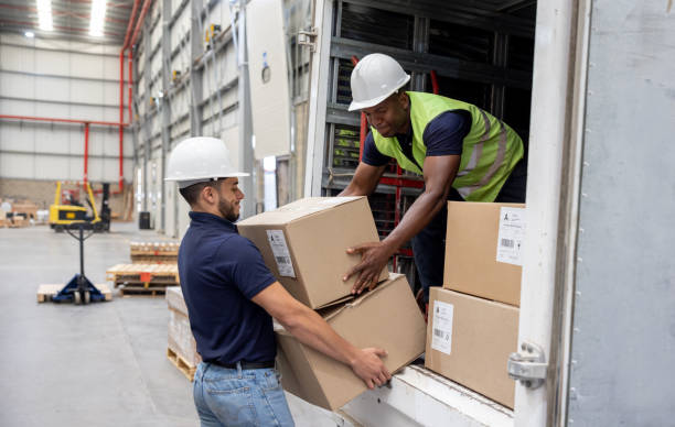 istock Team of workers loading boxes on a truck at a distribution warehouse 1474044589