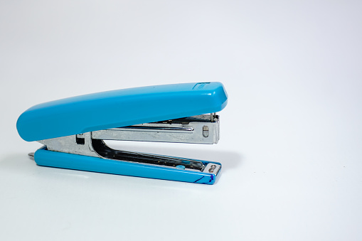 Blue stapler isolated on a white background.