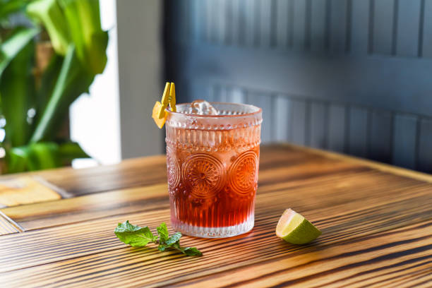 istock Alcohol cocktail on wooden table against dark wall with copy space 1474050334