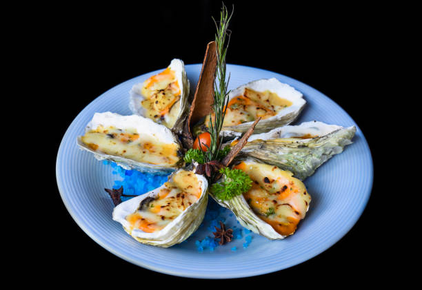 istock oysters baked with cheese on plate with blue salt isolated on black side view 1474050472