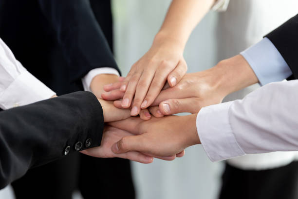 istock Top view closeup business team join hand stack together for harmony concept. 1474051348
