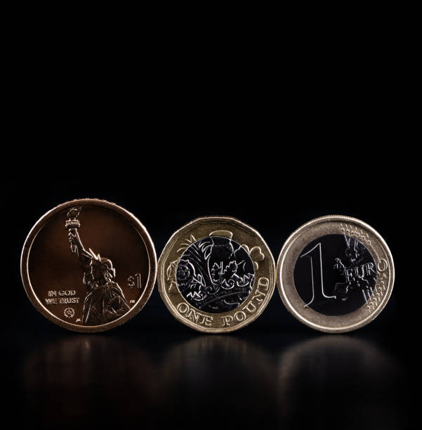 istock Coins american dollar, british pound and euro on black background 1474052371