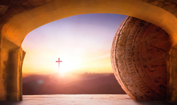 Easter and Good Friday concept, Empty Tomb At Sunrise With Sunlight Shining Through The Open Door And cross of christ Jesus In The Distance stock photo