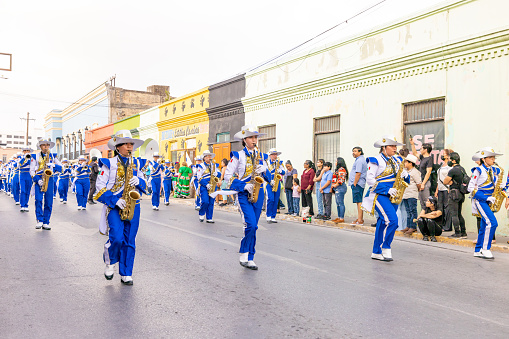 Matamoros, Tamaulipas, Mexico - February 25, 2023: Fiestas Mexicanas Parade, Members of the Toros Marching band from the Juan Jose de la Garza High School performing at the parade