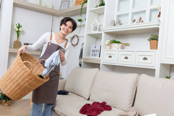 istock Happy Asian cleaner woman with laundry working at home. 1474062482