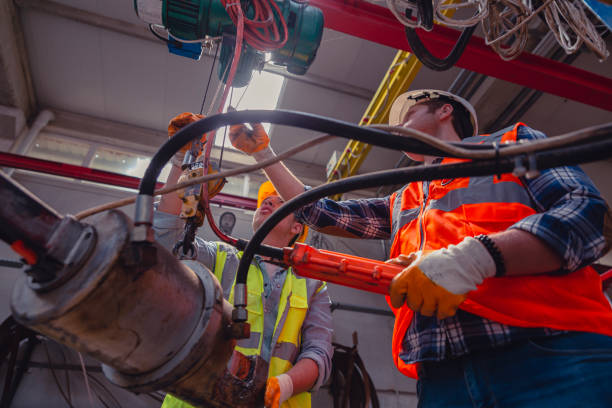 Industrial machinery male employees working with remote control for operating crane Skilled Industry worker and manager man using overhead crane controller and pushing button while managing crane at industrial tractor plant shop hydraulic platform stock pictures, royalty-free photos & images