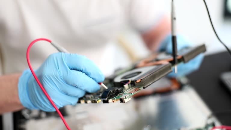 Computer engineer with tester inspects motherboard concept