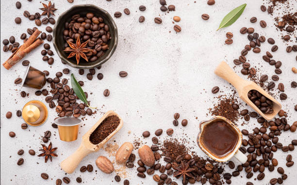 istock Background of various coffee , dark roasted coffee beans , ground and capsules with scoops setup on white concrete background with copy space. 1474065752