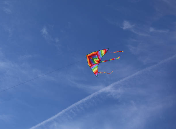 istock big kite with rainbow colors flies tied on string in the sky 1474068430