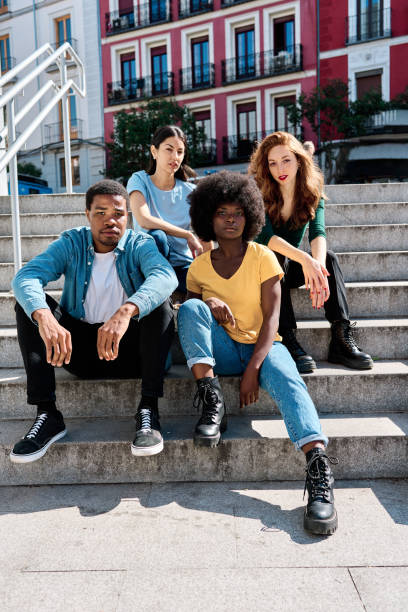 istock Multicultural group of friends sitting on urban stairs 1474068718