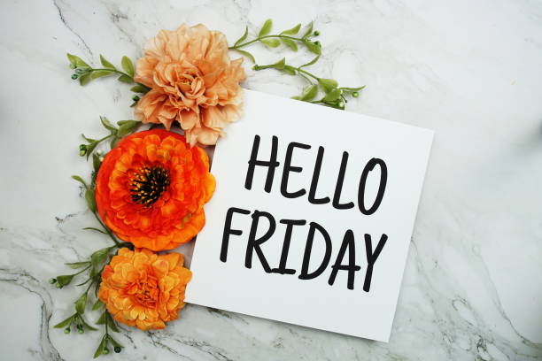 istock Hello Friday text with orange flower bouquet on marble background 1474071899