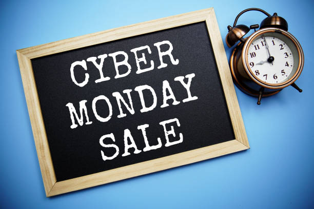 istock Cyber Monday Sale text message on Blackboard and alarm clock on blue background 1474072078