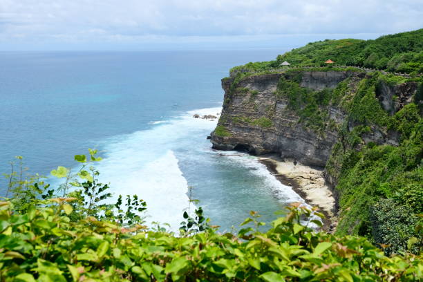 istock Dynamic Seaside Scene at Uluwatu Beach, Bali 1474072087