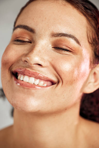 Skincare, natural beauty and face with a smile of happy person for dermatology, makeup and cosmetics. Facial, wellness and self care for freckles skin glow, teeth and a healthy model in studio cuidado de la piel, belleza natural y rostro con una sonrisa de persona feliz para dermatología, maquillaje y cosmética. facial, bienestar y cuidado personal para el brillo de la piel de las pecas, los dientes y un modelo saludable en el estudio