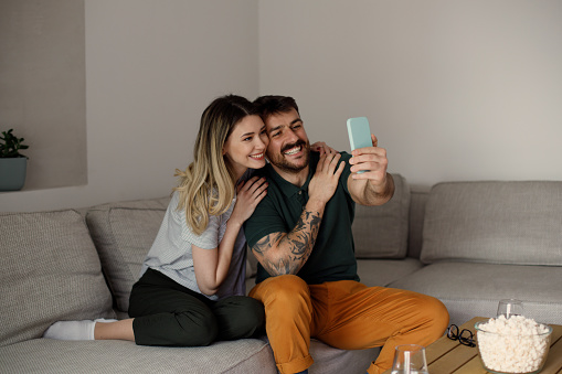 Close up of a happy young couple using a phone