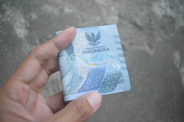 istock Closeup high resolution image of 2000 Rupiah banknote on hand 1474077824