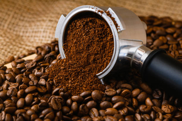 istock Beans and ground coffee background with holder 1474078309