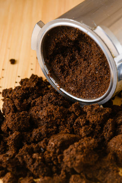 istock Spent or used coffee grounds with portafilter. 1474078350