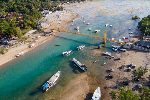 The yellow bridge which connect between Nusa Cheningan and Nusa Lembongan. Travel destination close to Bali island, Indonesia.