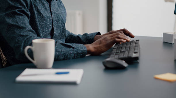 istock Black african american manager working from home, tuping on computer keyboard 1474082156