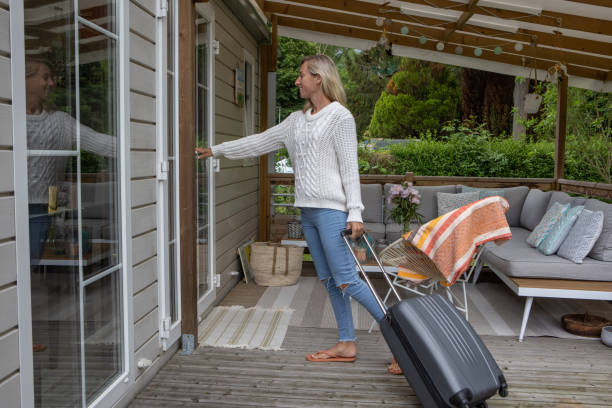 Woman arriving at her vacation rental cabin stock photo