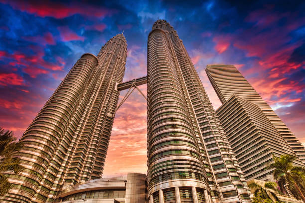 Petronas Towers sunset in Kuala Lumpur Kuala Lumpur, Malaysia - January 2023: The Petronas Twin Towers at sunset offer a picturesque and unforgettable view of one of the world's most iconic landmarks of Malaysia. twin towers malaysia stock pictures, royalty-free photos & images