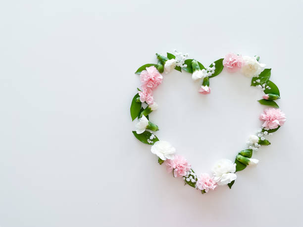 istock Frame in form of heart from pink, white carnations 1474085540