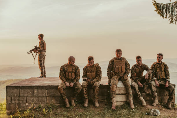 istock Soldiers squad relaxing after battle having a break on training 1474088460