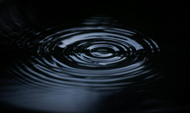 istock Ripple of water or water drop splash on black background. 1474089251
