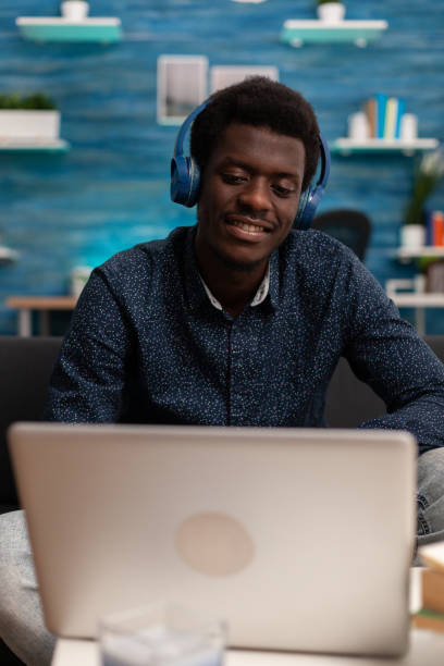 istock African american student wearing headphone having audio business course 1474090000