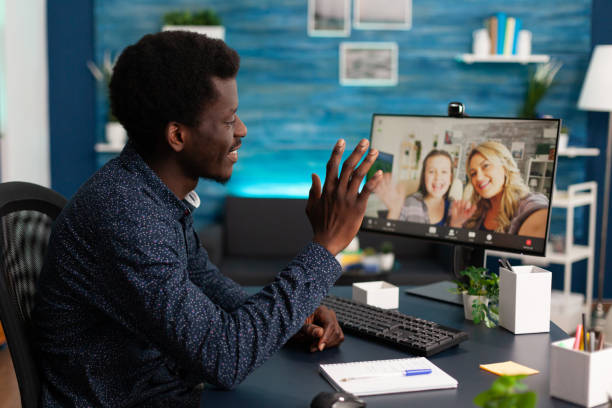 istock Man student greeting remote friends enjoying freetime 1474090411