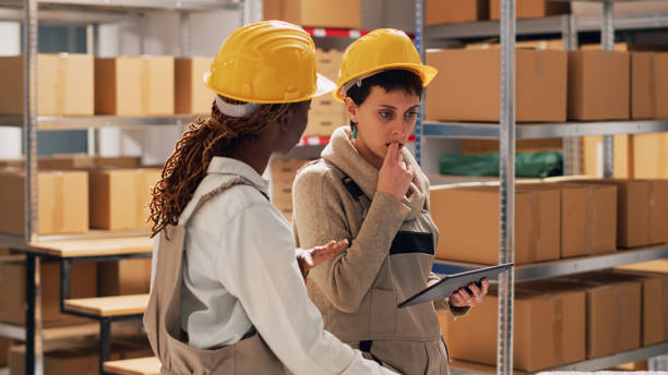 istock Female supervisors in depot using digital tablet to work 1474092513