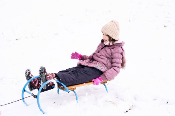 istock Happy girl on a sled during winter day 1474094235