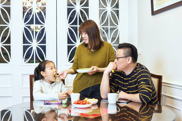 istock A couple and their daughter talking happily while sitting at the dining table 1474095477