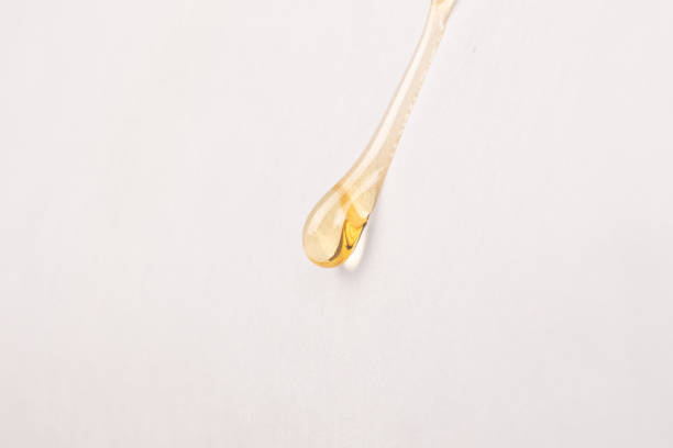 istock cannabis wax resin golden drop down on white paper closeup 1474097567