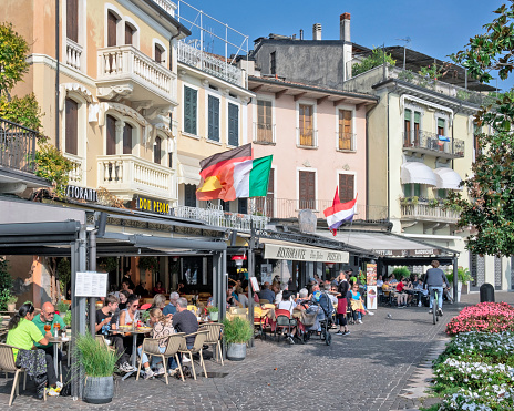 Salo, Italy - October 17, 2022: Local architecture, restaurants, cafes and people in Salo, Italy.