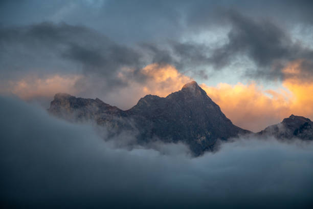 istock Striking mountain formation under blue sky surrounded by clouds 1474099405