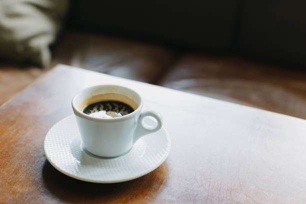 istock Cup of black coffee on a table in a cafe. Selective focus. 1474099777