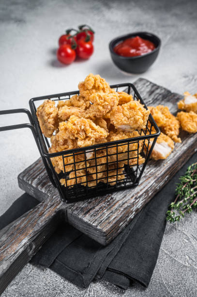 istock Dip Fried chicken popcorn with ketchup in a basket. White background. Top view 1474101800