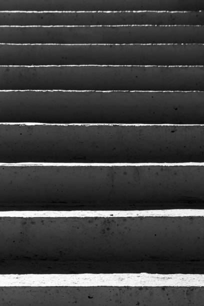 istock Concrete stairs with dark shadows, abstract vertical photo 1474101852
