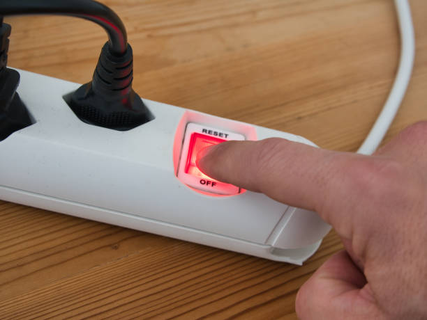 istock Press the red illuminated power switch on a white power strip, energy saving 1474102162