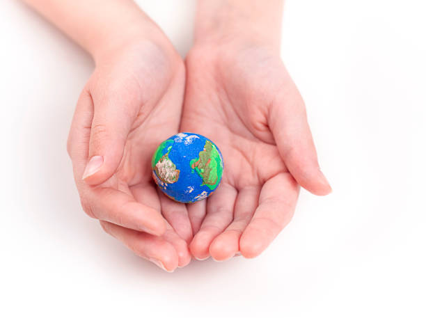 istock A child holds a small plasticine globe with both hands. 1474103284
