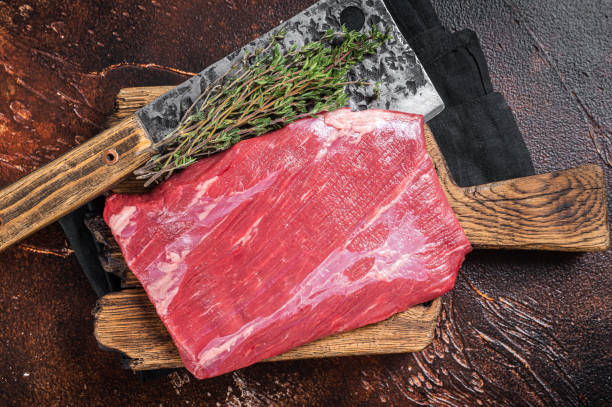 istock Alternative raw flap flank beef meat steak on butcher board. Dark background. Top view 1474103493