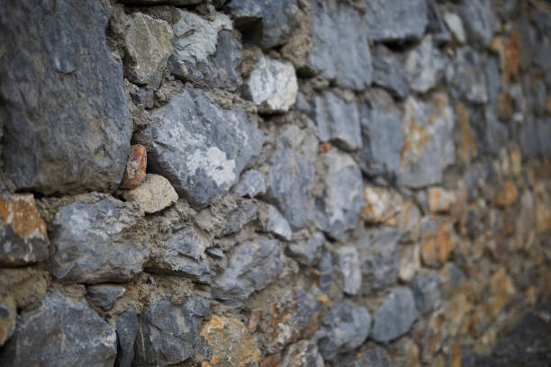 perspective view with blurred background from a natural blue gray colored stone retaining wall