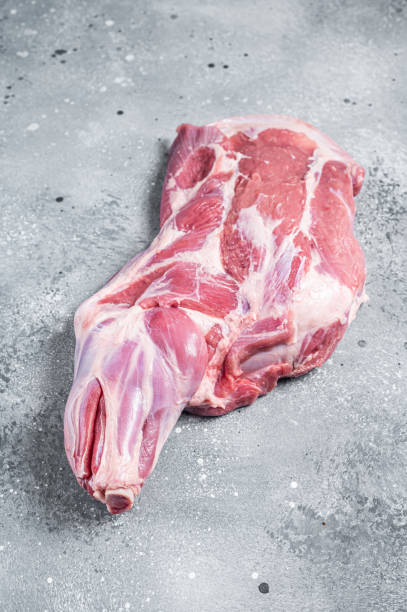 istock Raw lamb shoulder meat on butcher table. Gray background. Top view 1474105138