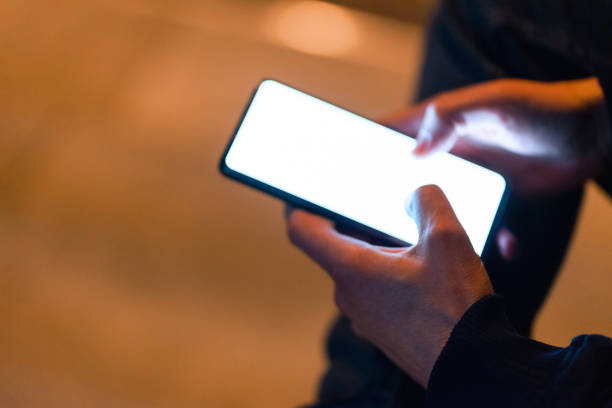 istock Using a smartphone in the city at night 1474106083