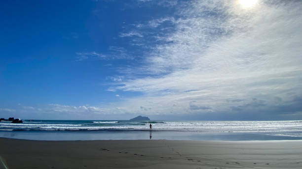 istock A surfer is walking into the sea with a surfboard for practice 1474107737
