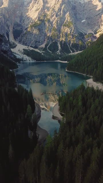 Aerial view of Lago di Braies lake and Seekofel peak at sunrise, Dolomites, Italy