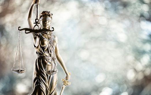 Law and legal background, statue of Lady Justice with scales of justice with cpy space
